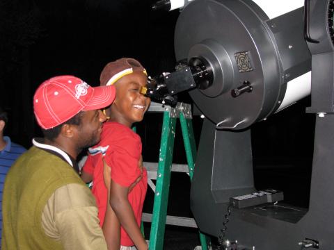 Father and son take a peek through the telescope